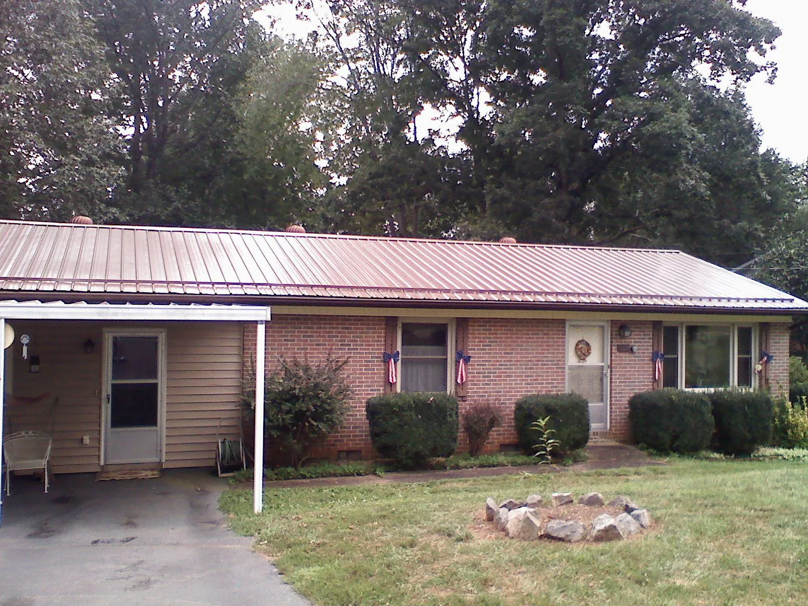 Bronze metal roof and carport on a brick ranch home — Roof Repair work by our crew in Mechanicstown