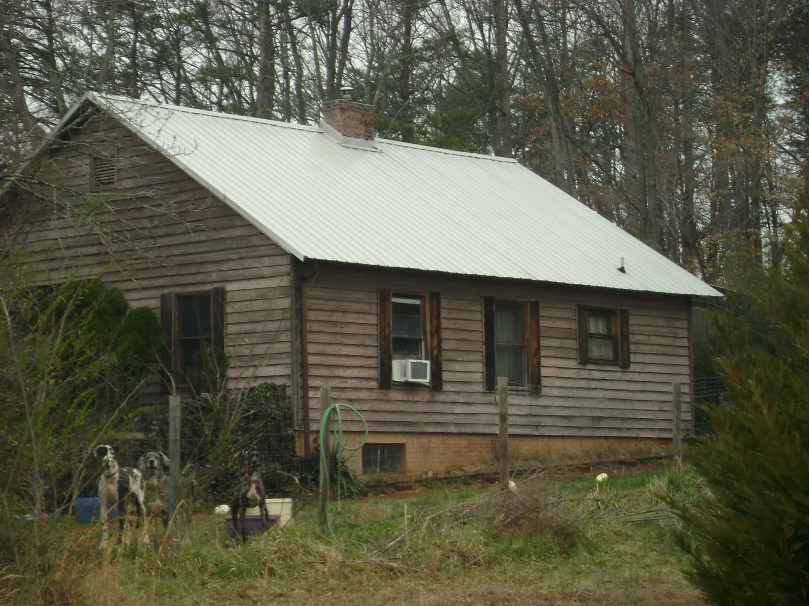 White metal roof on an old wood sided farmhouse, from a Metal Roof Installation job in Mechanicstown